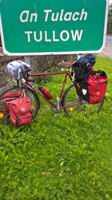 Bike by a white-on-green sign An Tulach / TULLOW